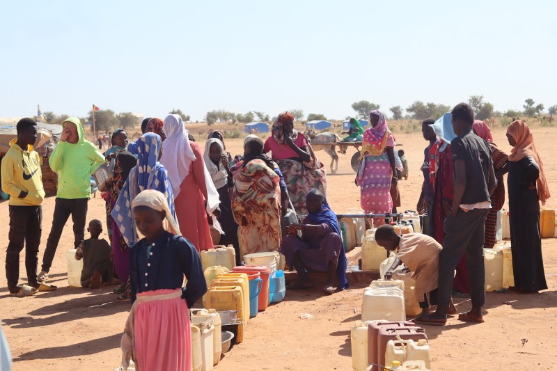 Refugees fleeing the conflict in Sudan queue with their jerrycans to queue to collect drinking water from the Doctors Without Borders (MSF) distribution point at the Ourang refugee camp in Adre on Dec. 7, 2023.