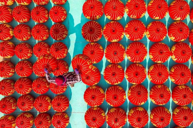 Seen from above, a worker arranges red lanterns for upcoming Lunar New Year celebrations in Huaian, China.