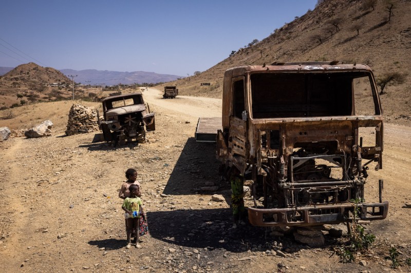 Children look at burnt out trucks that were destroyed during the war on Feb. 18 in Tigray Region, Ethiopia.