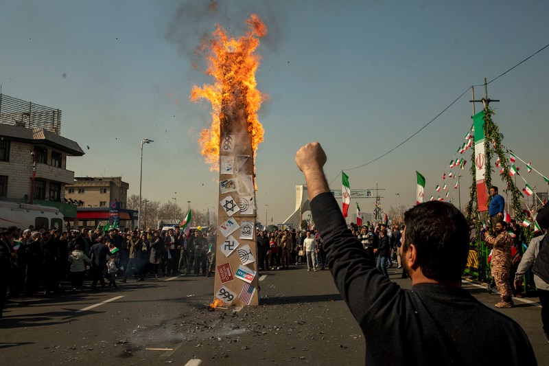Iranians celebrate the anniversary of the 1979 Islamic Revolution, burning symbols and photos of European and American leaders, in Tehran on Feb. 11.