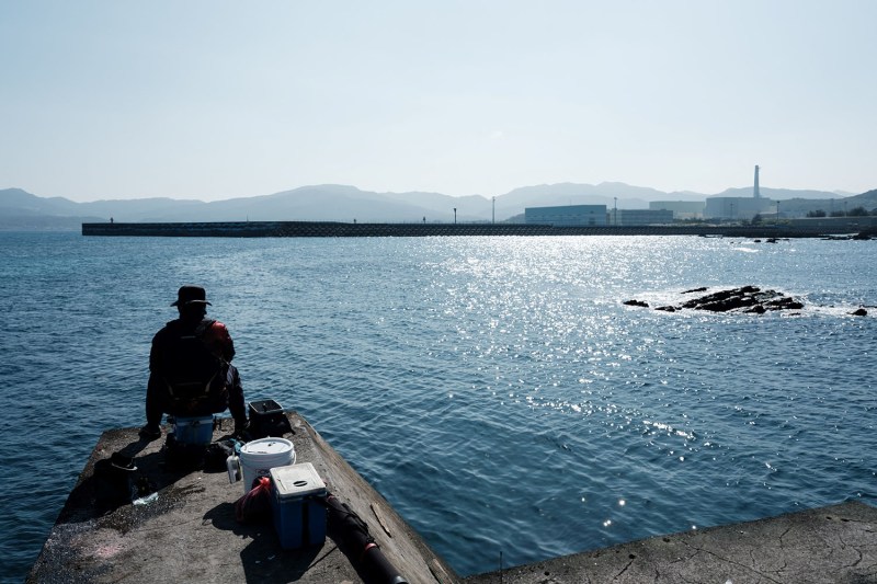 A man fishes at a port near the Lungmen, a nuclear power plant that has suspended its construction, in New Taipei City.