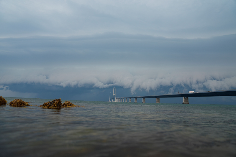 Dark clouds hang over the Great Belt Bridge connecting Nyborg and Halsskov, Denmark, on June 26, 2023. (