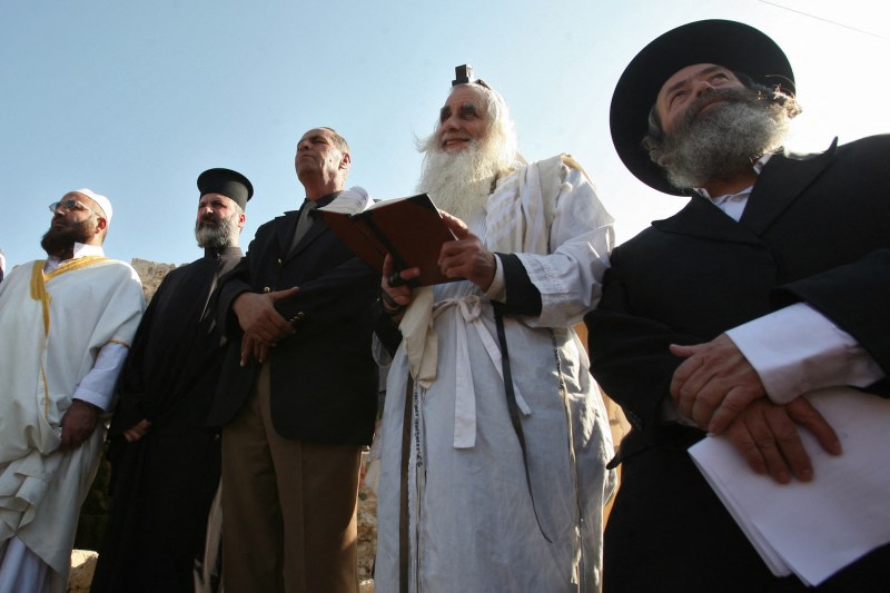 An Muslim imam, a Christian priest and two Jewish rabbis join a prayer calling for rain on November 11, 2010 in the West Bank village of Walajeh near Bethlehem.