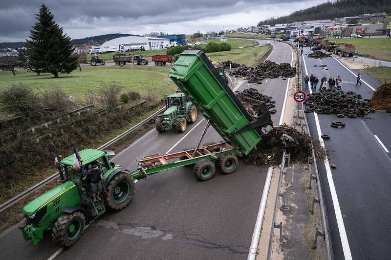 A farmer dumps waste to block a highway near Vesoul, France, on Jan. 25.