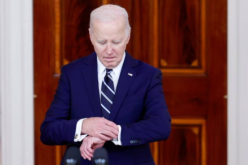 U.S. President Joe Biden looks at his watch as he arrives to give remarks with King of Jordan Abdullah II ibn Al Hussein at the White House on Feb. 12, 2024 in Washington.