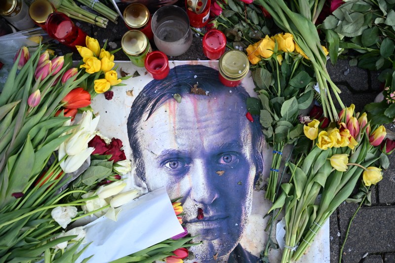 Flowers are seen placed around a portrait of late Russian opposition leader Alexei Navalny at a makeshift memorial in Frankfurt am Main, Germany, on Feb. 29.