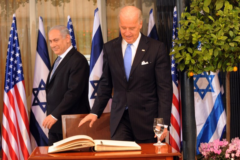 Benjamin Netanyahu walks past Joe Biden as he prepares to sign the guestbook at the Prime Minister's residence on March 9, 2010 in Jerusalem.