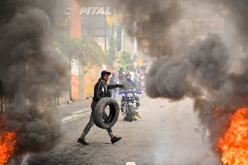 A protester burns tires during a demonstration calling for the resignation of acting Prime Minister Ariel Henry in Port-au-Prince, Haiti.