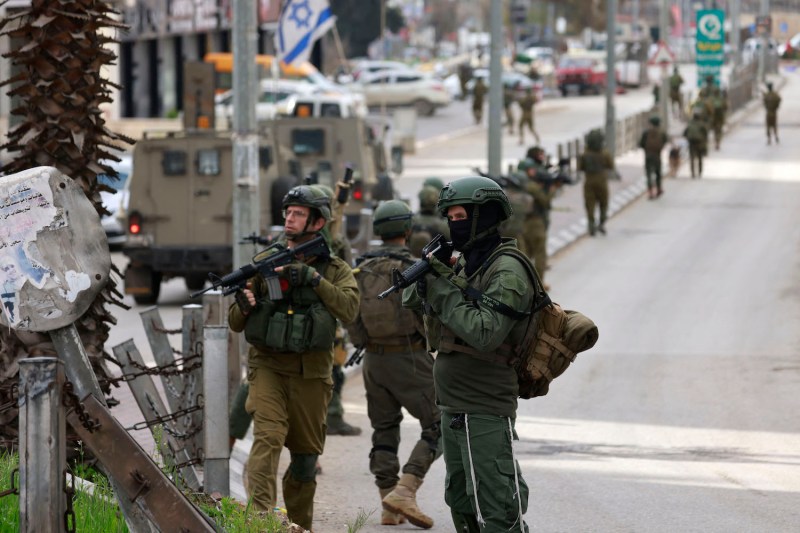 Israeli troops raid the al-Amari refugee camp in the West Bank.
