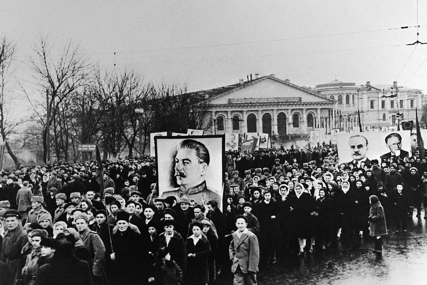 People carry posters of Soviet leader Joseph Stalin and other Soviet leaders in Moscow.