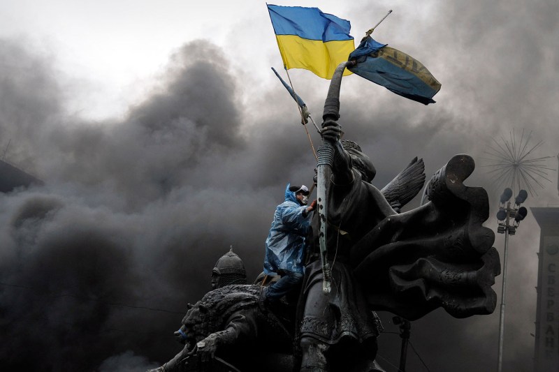 A protester sits on a monument in central Kyiv during the Maidan uprising on Feb. 20, 2014.