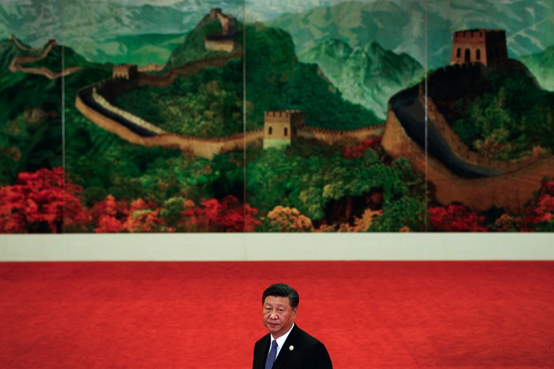 Chinese President Xi Jinping waits in front of a painting of the Great Wall at the Great Hall of the People in Beijing.