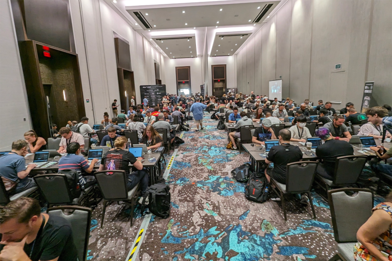 People participate in an AI red-teaming exercise at the DEF CON hacking conference in Las Vegas.