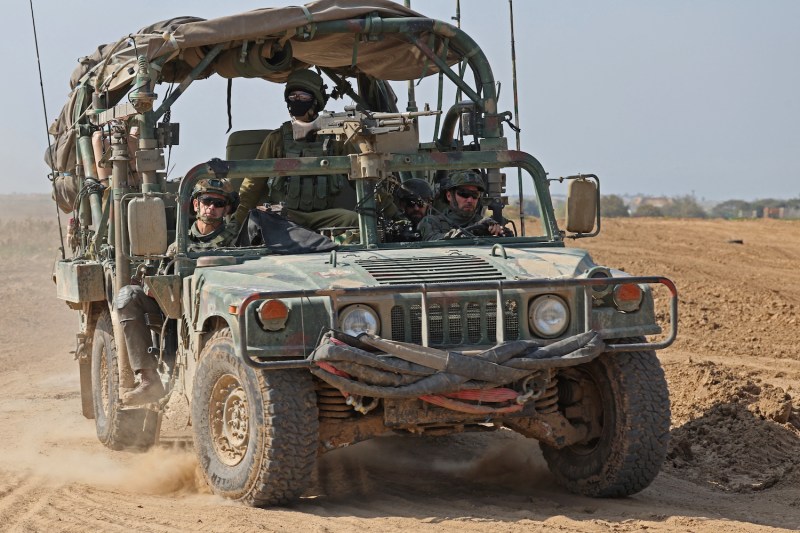 An Israeli army vehicle moves along the border with the Gaza Strip on Feb. 28, amid ongoing fighting between Israel and Hamas militants.