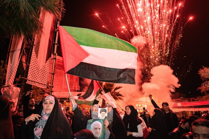 Iranian pro-government supporters shout anti-Israel slogans while waving the Palestine flag at Palestine Square in Tehran, on April 14, 2024, in a celebration of the early morning Iran's IRGC attack on Israel.
Iran fired over 100 drones and ballistic missiles on Saturday, April 14, 2024, in retaliation to an attack on a building attached to the country's consular annex in Damascus that killed seven members of the Quds Force of Iran's Islamic Revolutionary Guard Corps (IRGC) on April 01, 2024. Iran has blamed Israel for the attack on April 5, 2024 in Tehran. (Photo by Hossein Beris / Middle East Images / Middle East Images via AFP) (Photo by HOSSEIN BERIS/Middle East Images/AFP via Getty Images)