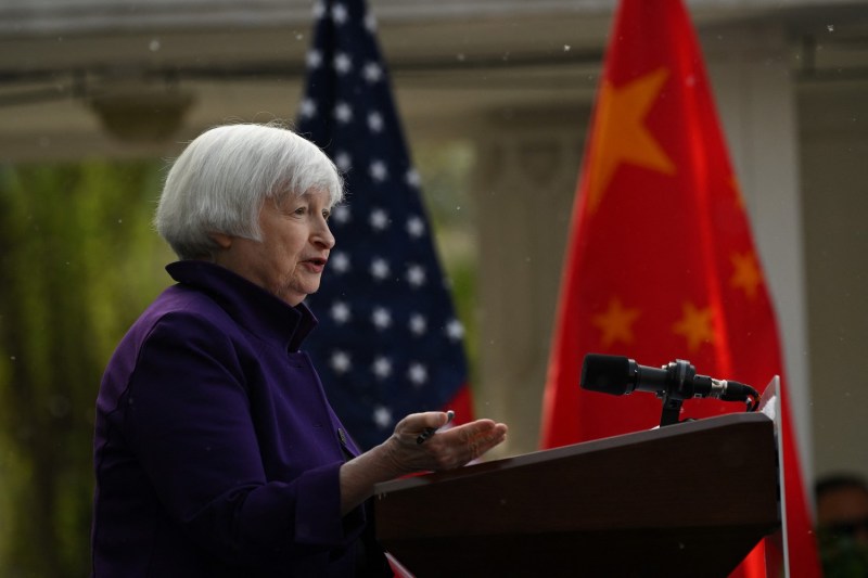 U.S. Treasury Secretary Janet Yellen speaks into a microphone at a podium while she attends a press conference.
