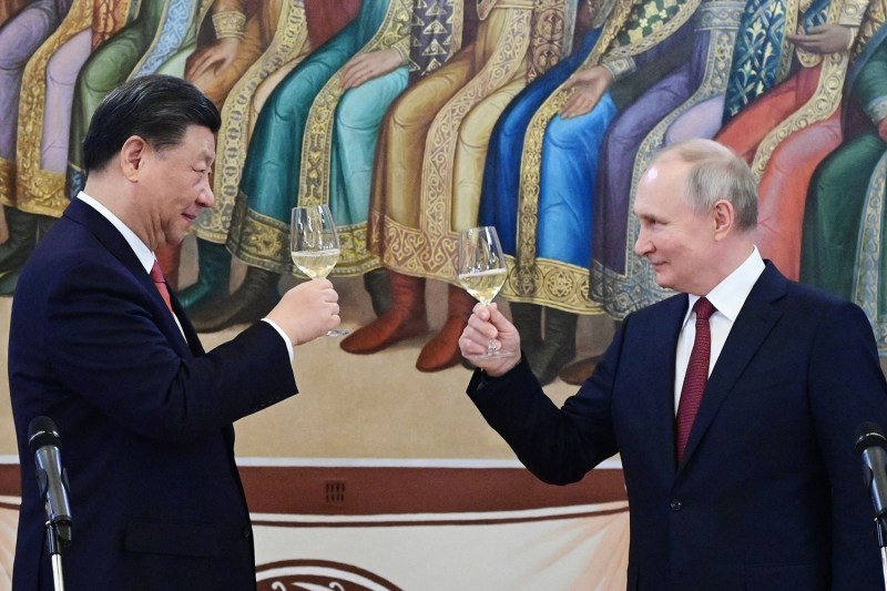 Russian President Vladimir Putin and Chinese President Xi Jinping make a toast during a reception following their talks at the Kremlin in Moscow.