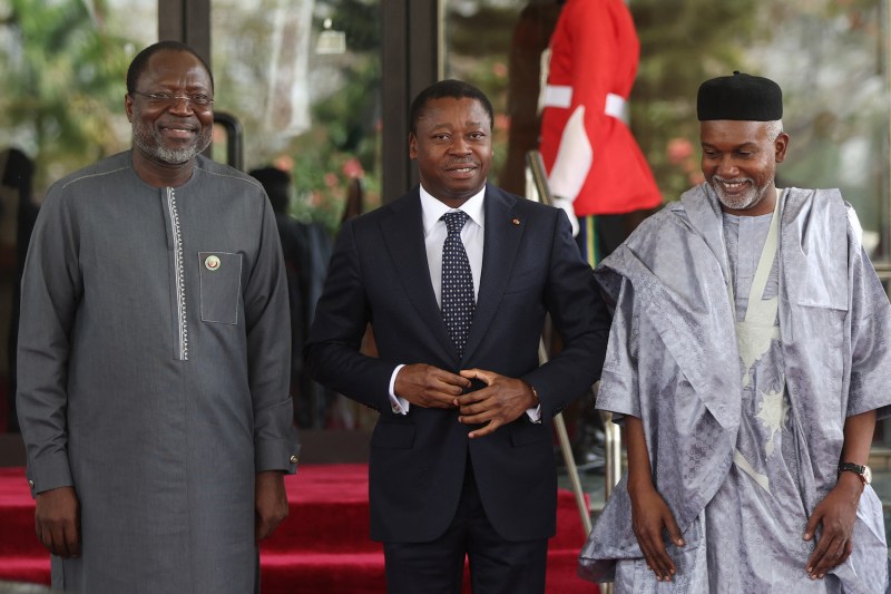 Togolese President Faure Gnassingbé is received by the president of the Economic Community of West African States Commission, Omar Touray (left), and Nigerian Foreign Affairs Minister Yusuf Tuggar (right) at the presidential villa in Abuja, Nigeria, on Feb. 24.