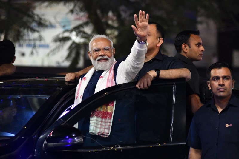 Indian Prime Minister Narendra Modi waves to supporters at an election campaign event in Guwahati, India.