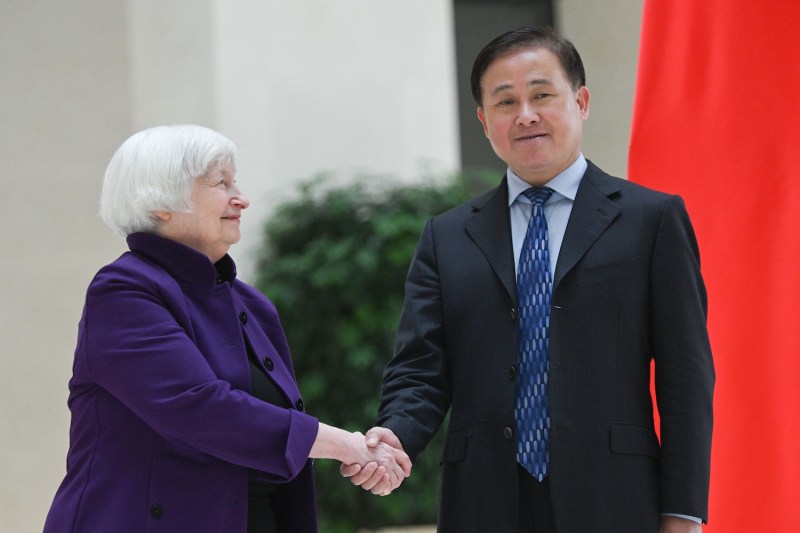 U.S. Treasury Secretary Janet Yellen shakes hands with Pan Gongsheng, the governor of the People’s Bank of China, during her visit to the central bank’s headquarters in Beijing.