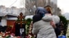 Mourners react by the grave of Russian opposition leader Alexei Navalny at the Borisovo cemetery in Moscow on March 2, 2024, the next day after Navalny's funeral. (Photo by Olga MALTSEVA / AFP)