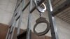 Handcuffs hanging on bars
