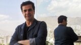 IRAN -- (FILES) In this file photo taken on August 30, 2010 Iranian film director Jafar Panahi on a balcony overlooking Tehran during an interview with AFP. - Dissident Iranian filmmaker Jafar Panahi, who won a Golden Bear at the Berlin film festival in 2