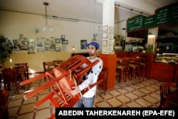 An Afghan migrant working in his cafe in Tehran (file photo)