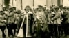 Regele Ferdinand și Regina Maria la încoronarea lor drept suverani ai României Unite, la 15 octombrie 2022. De la intrarea țării în război pentru Transilvania, în august 1916, până la nepotul lor, Regele Mihai I, numele dinastiei domnitoare la București a fost „de România”. 