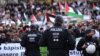 Police officers watch protesters during a 'March for Palestine' calling for a ceasefire in the war between Israel and Hamas, in Dortmund, western Germany on October 28, 2023.