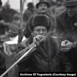 Tito lights his cigar from a smoldering stick from a bonfire during a gathering of foreign diplomats in Karadjordjevo, a village near Novi Sad in present-day Serbia.