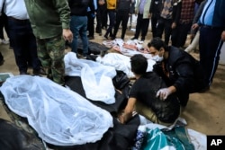 Relatives identify the bodies of some of the 90 people who were killed in explosions in the Iranian city of Kerman in January that were blamed on IS-K.