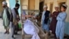 Relatives stand around the dead body of a victim of a suicide bomb attack in Kandahar on March 21. 
