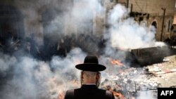 Ultra-Orthodox Jews burn leavened items during the Biur Chametz ritual in Jerusalem's Mea Sharim district, during the final preparations before the start of the week-long Jewish Passover holiday. 