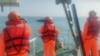 台灣海巡署公佈照片顯示2024年2月14日海巡人員在金門海域調查一艘中國籍快艇越界進入禁區水域。