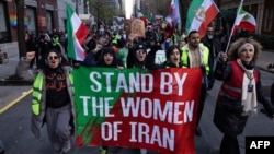 FILE - Protesters call on the United Nations to take action against the treatment of women in Iran, following the death in police custody of Mahsa Amini, during a rally in New York City, Nov. 19, 2022.