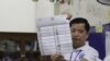 FILE - A Cambodian election official in Phnom Penh shows the national election ballot on June 23, 2023. (Lors Liblib/VOA Khmer )