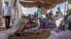 FILE - Refugees collect food rations from the U.S. Agency for International Development at a distribution point in eastern Sudan, March 24, 2021. USAID says it may need to cut its response to global crises because of U.S. budget cuts. 