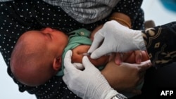 (FILE) - A baby receives the Bacillus Calmette-Guerin (BCG) vaccine for tuberculosis in Indonesia