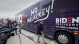 FILE - Democratic presidential candidate and former Vice President Joe Biden boards his "No Malarkey" bus following a campaign stop in Council Bluffs, Iowa on Nov. 30, 2019. (AP Photo/Nati Harnik)
