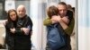 (FILE) Hostages Fernando Marman and Louis Har hug relatives after being rescued from captivity in the Gaza Strip, in Ramat Gan, Israel, Feb. 12, 2024.