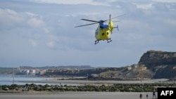 A helicopter of the Emergency medical services takes off from the Wimereux dike on April 23, 2024, after the recovery of the body of five migrants, who died overnight trying to cross the Channel from France to Britain on their overcrowded small boat. 