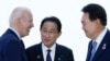 FILE - President Joe Biden, left, talks with Japan's Prime Minister Fumio Kishida and South Korean President Yoon Suk Yeol, right, ahead of a trilateral meeting on the sidelines of the G7 Summit in Hiroshima, Japan, May 21, 2023. 