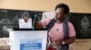 A voter casts her ballot in Togo's regional elections in the capital, Lome, April 29, 2024. 