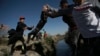 Migrants cross the Rio Grande river into the United States from Ciudad Juarez, Mexico, March 29, 2023. The image was part of a series by Associated Press photographers that won the 2024 Pulitzer Prize for feature photography.