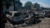 The charred remains of vehicles that were burned near a garage are seen in Port-au-Prince, Haiti, on March 25, 2024.