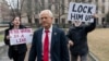 FILE - Former Trump White House official Peter Navarro, followed by demonstrators, leaves the U.S. Federal Courthouse in Washington, Jan. 25, 2024. 