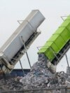 FILE - Garbage is loaded into a landfill in Lenox Township, Mich., July 28, 2022. A new United Nations report estimates that 19% of the food produced around the world went to waste in 2022. 