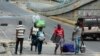 People flee an area where gang violence occurred in Port-au-Prince, Haiti, on April 26, 2024. 