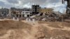 Volunteers walk as they search for dead bodies in a damaged area in the aftermath of the floods in Derna, Libya, Sept. 18, 2023.